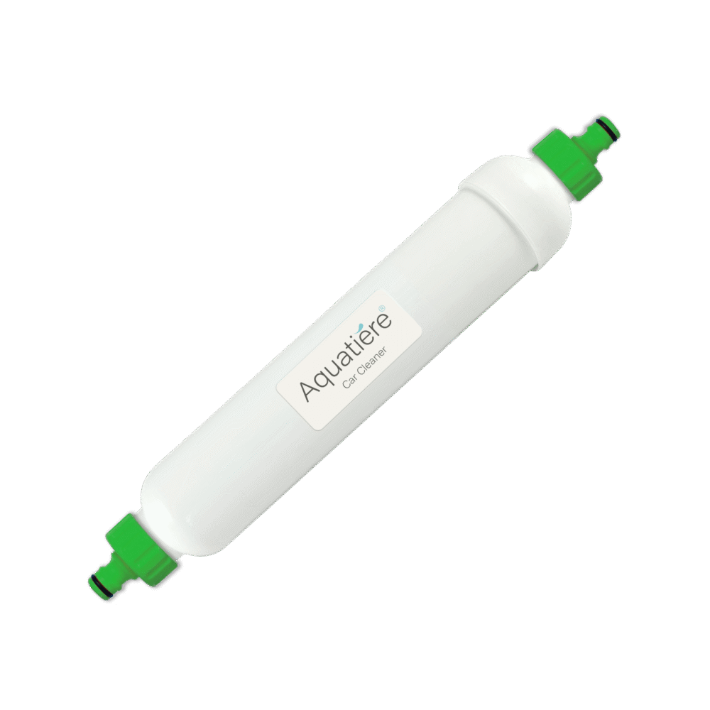 The car cleaner filter, a long white container with green hose attachment ends, angled.